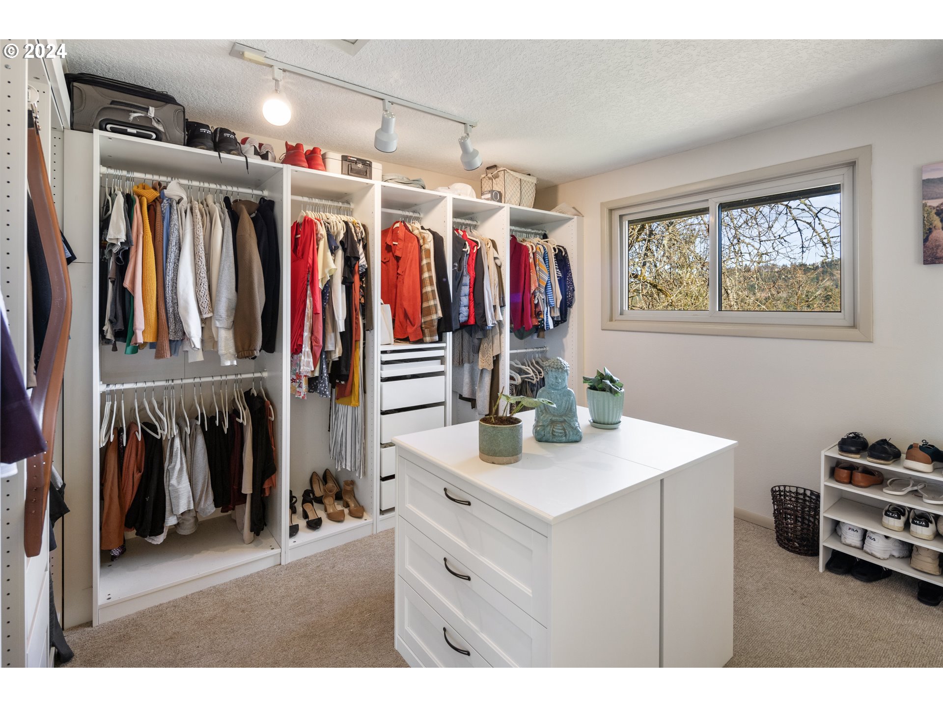 4335 Southwest Cullen Boulevard Portland, OR 97221 - Photo 21 of 46 a view of walk in closet with clothes and shoes