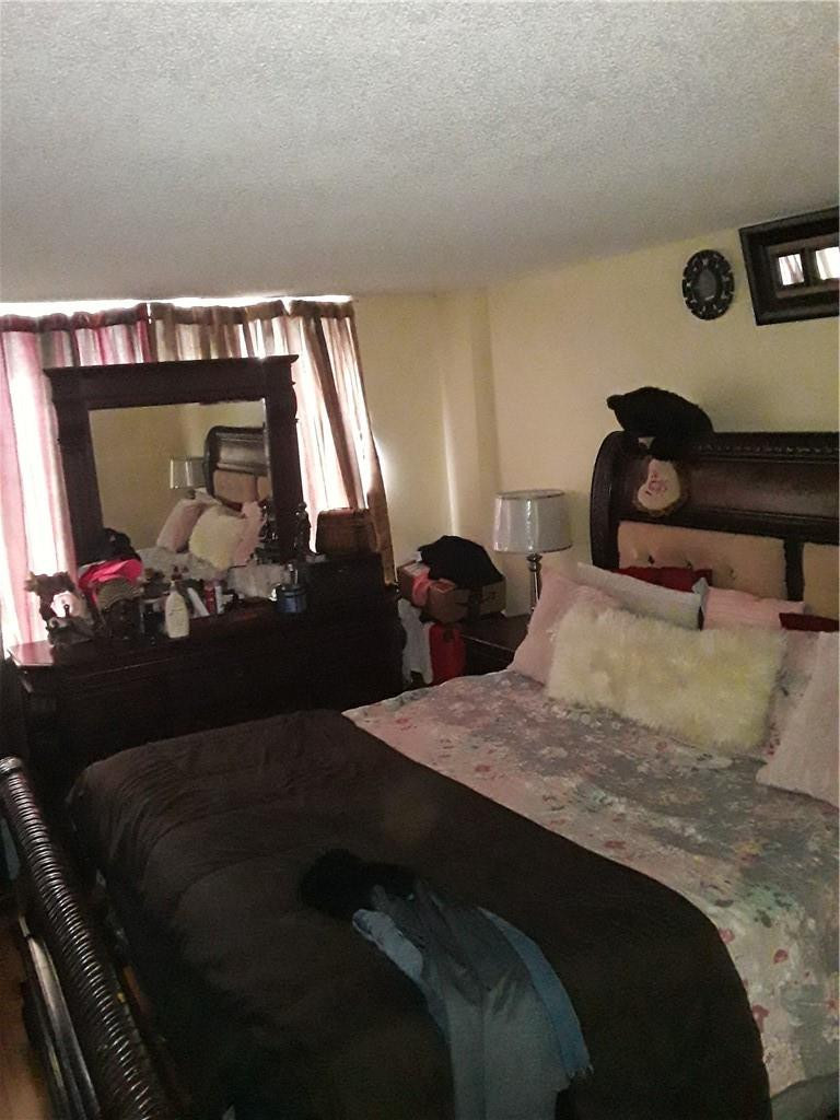 4222 Inverrary Boulevard, Unit 4610 Lauderhill, FL 33319 - Photo 12 of 32 a bedroom with a bed and a mirror