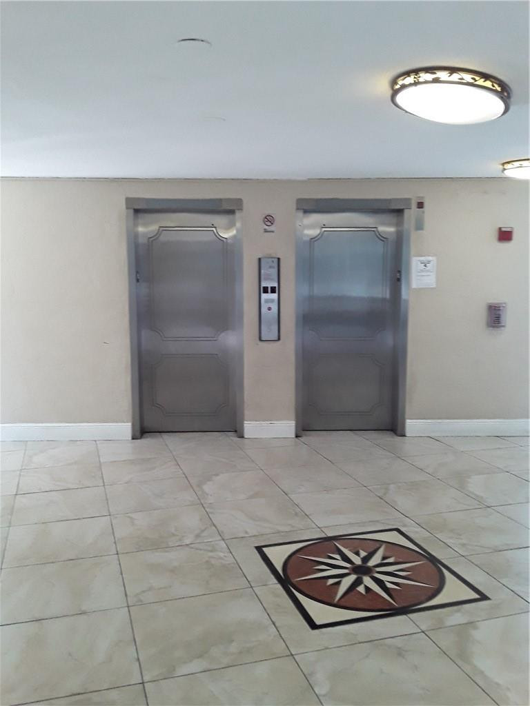 4222 Inverrary Boulevard, Unit 4610 Lauderhill, FL 33319 - Photo 21 of 32 a room with a table and a chandelier