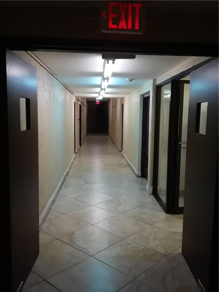 4222 Inverrary Boulevard, Unit 4610 Lauderhill, FL 33319 - Photo 27 of 32 a view of a hallway with an empty space