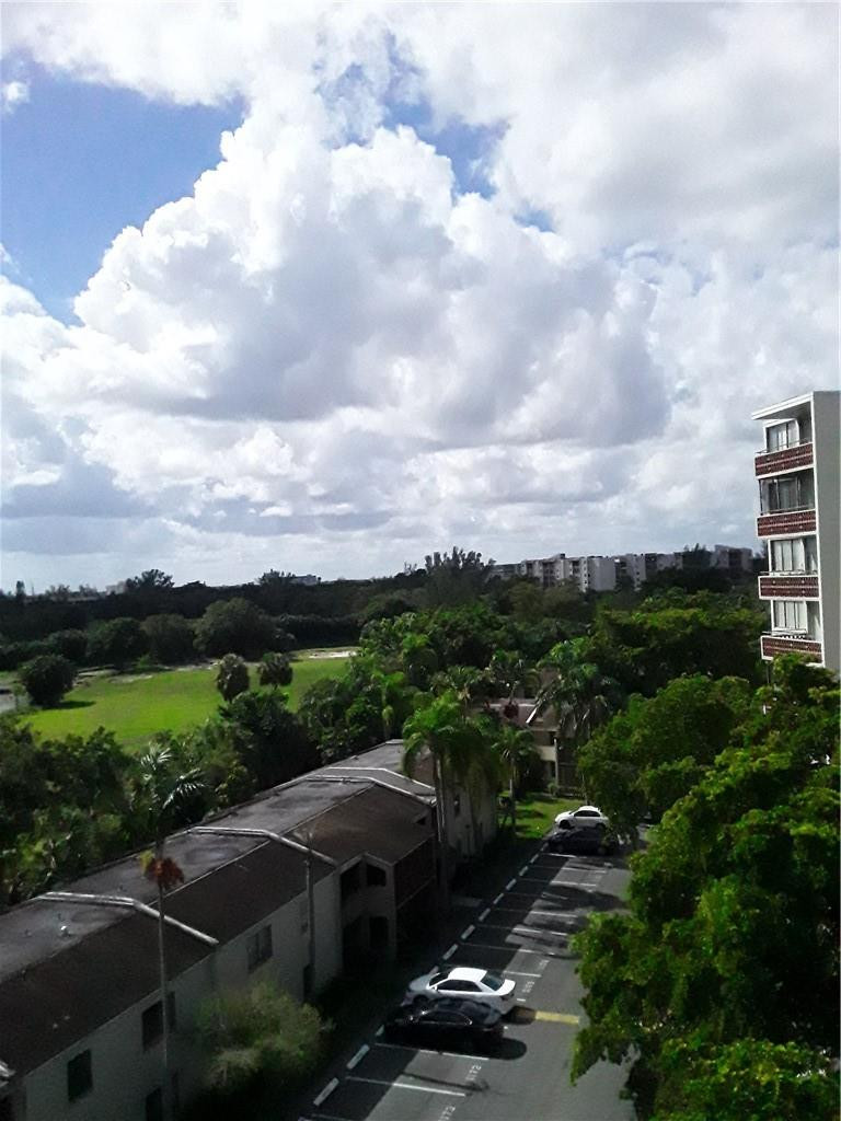 4222 Inverrary Boulevard, Unit 4610 Lauderhill, FL 33319 - Photo 28 of 32 an aerial view of a city with lots of residential buildings ocean and mountain view in back