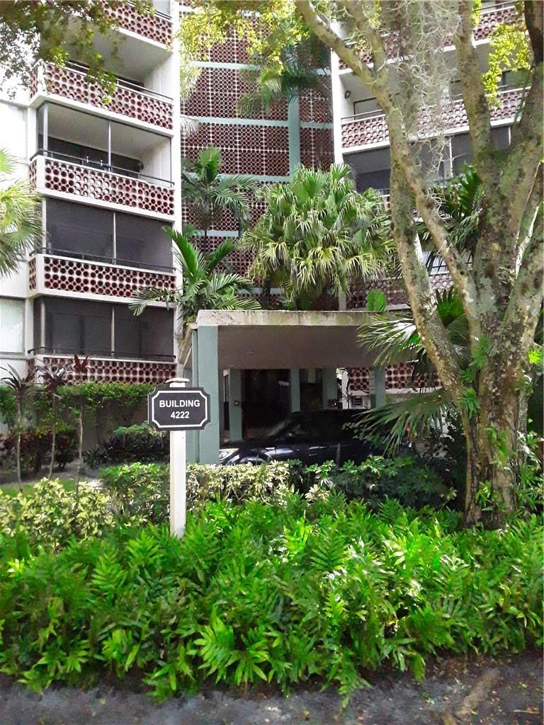 4222 Inverrary Boulevard, Unit 4610 Lauderhill, FL 33319 - Photo 6 of 32 a front view of a house with a yard and potted plants
