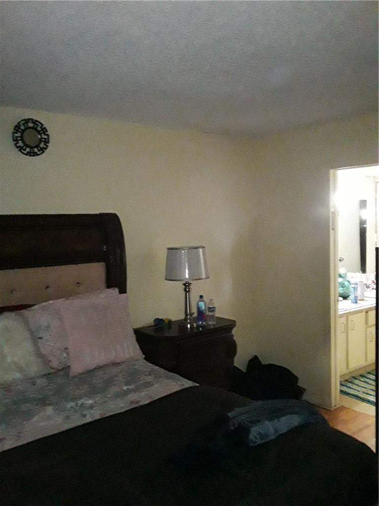 4222 Inverrary Boulevard, Unit 4610 Lauderhill, FL 33319 - Photo 10 of 32 a bedroom with a bed and a window