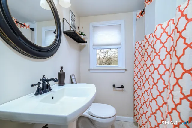 a bathroom with a sink a mirror and a toilet
