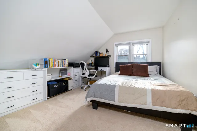 a bedroom with a bed and window
