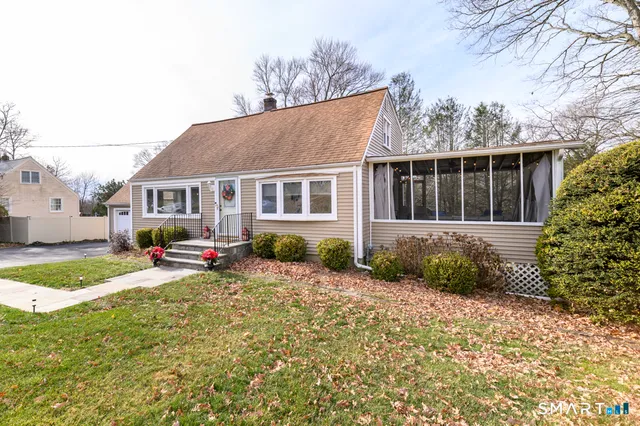 a view of a house with a yard and sitting area