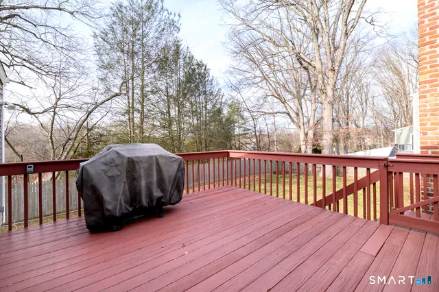 a terrace of a house with wooden floor and fence