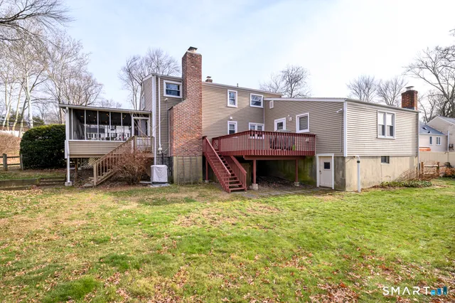 a view of a house with backyard porch and sitting area