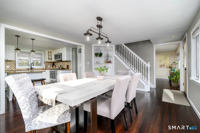 a view of a dining room with furniture wooden floor and chandelier