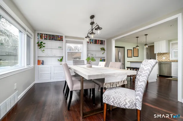 a view of a dining room with furniture and wooden floor