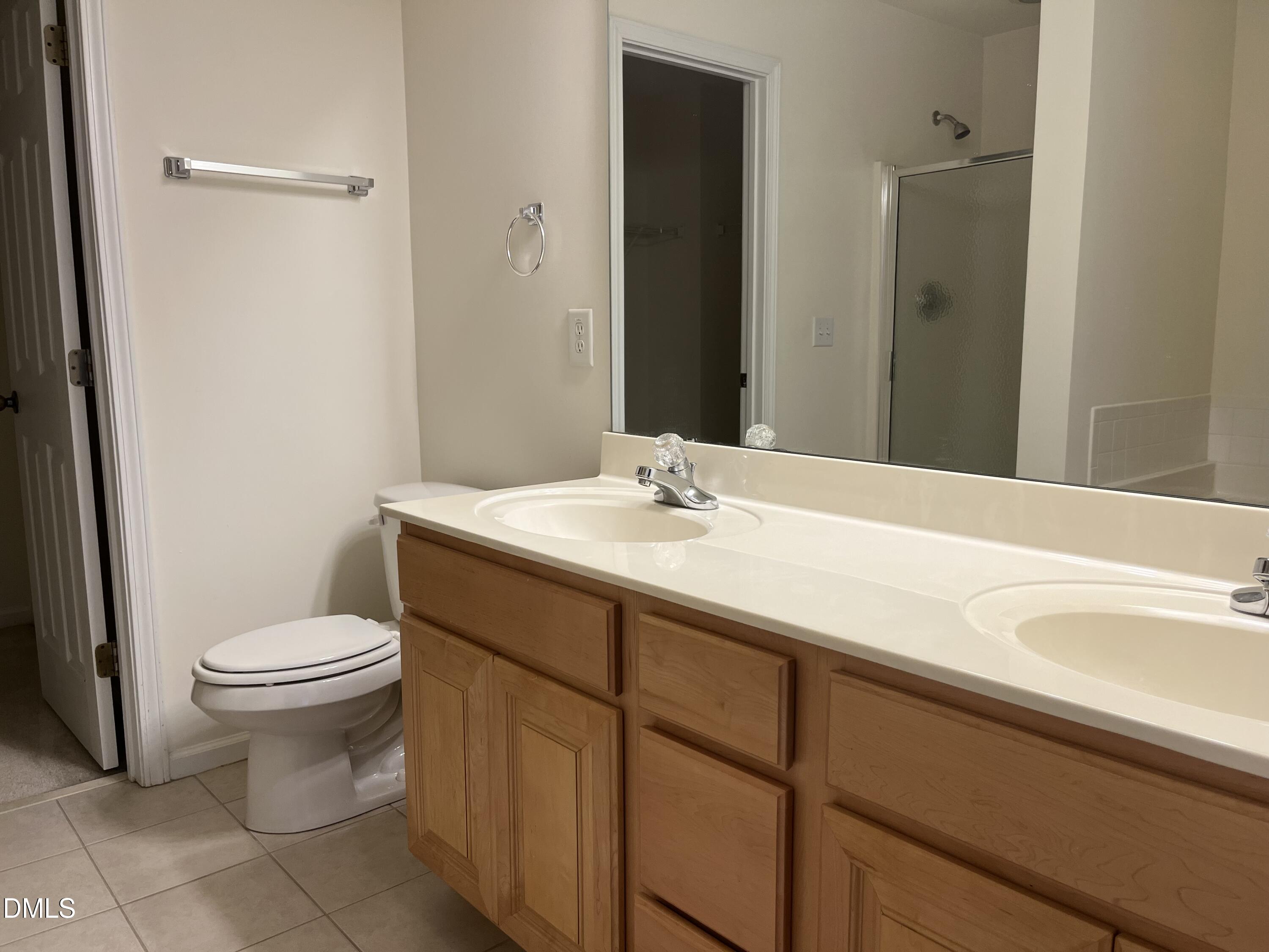 9827 Grettle Court Raleigh, NC 27617 - Photo 9 of 10 a bathroom with a sink toilet and shower