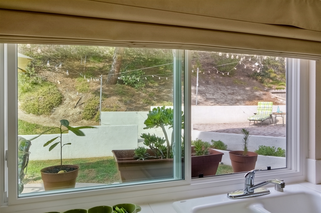 447 Mainsail Road Oceanside, CA 92054 - Photo 6 of 25 Kitchen window and screen opens to backyard!