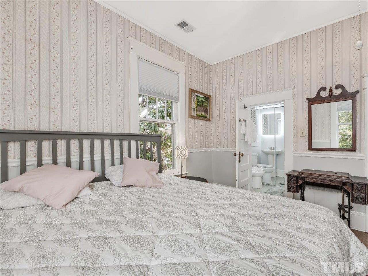 216 Hillcrest Road Raleigh, NC 27605 - Photo 28 of 49 a large bedroom with a bed and a window