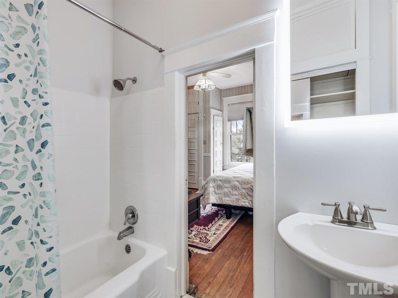 216 Hillcrest Road Raleigh, NC 27605 - Photo 29 of 49 a bathroom with a sink and a mirror