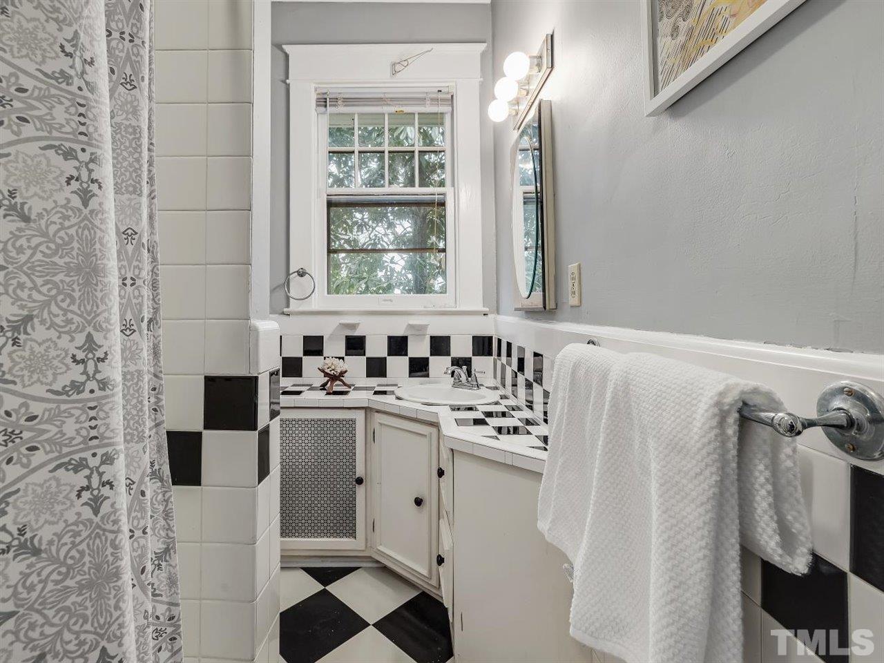 216 Hillcrest Road Raleigh, NC 27605 - Photo 32 of 49 a bathroom with a sink and a mirror