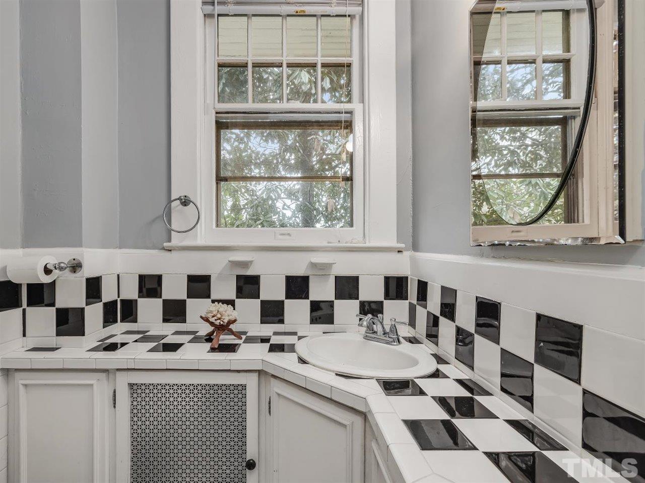216 Hillcrest Road Raleigh, NC 27605 - Photo 33 of 49 a kitchen with a sink a stove a window and cabinets