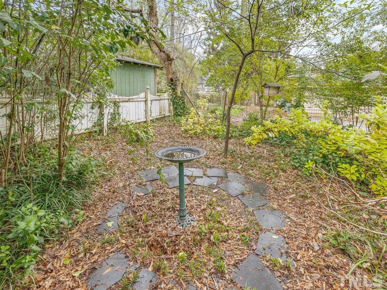 216 Hillcrest Road Raleigh, NC 27605 - Photo 43 of 49 a backyard of a house with table and chairs