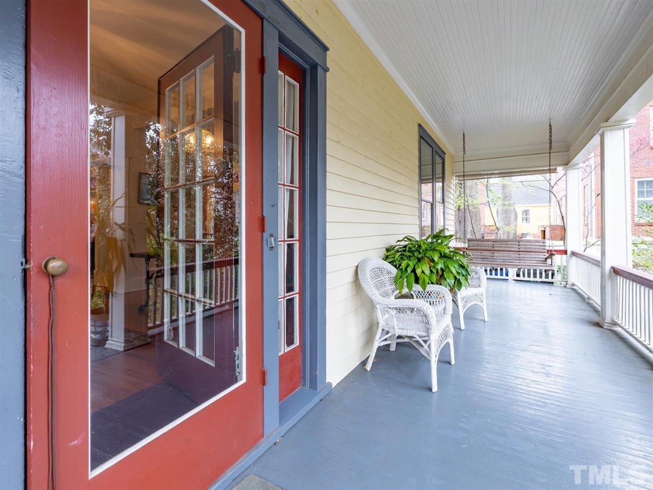 216 Hillcrest Road Raleigh, NC 27605 - Photo 6 of 49 a view of a porch with chairs and dining table