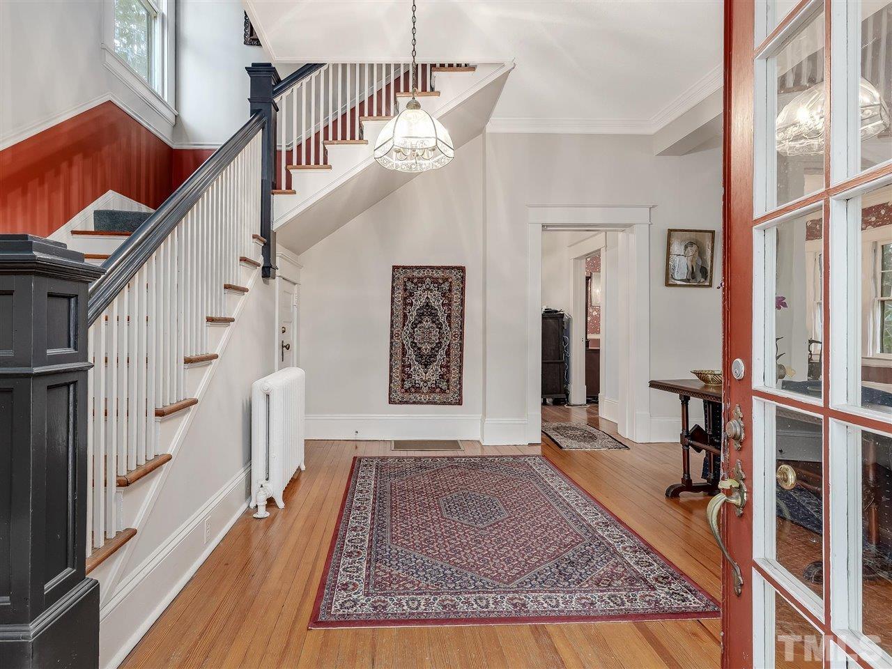 216 Hillcrest Road Raleigh, NC 27605 - Photo 7 of 49 a view of staircase with white walls and a rug