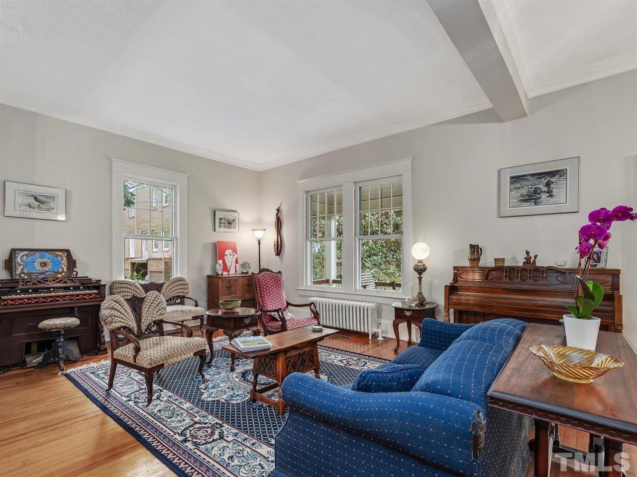 216 Hillcrest Road Raleigh, NC 27605 - Photo 9 of 49 a living room with furniture fireplace and a window