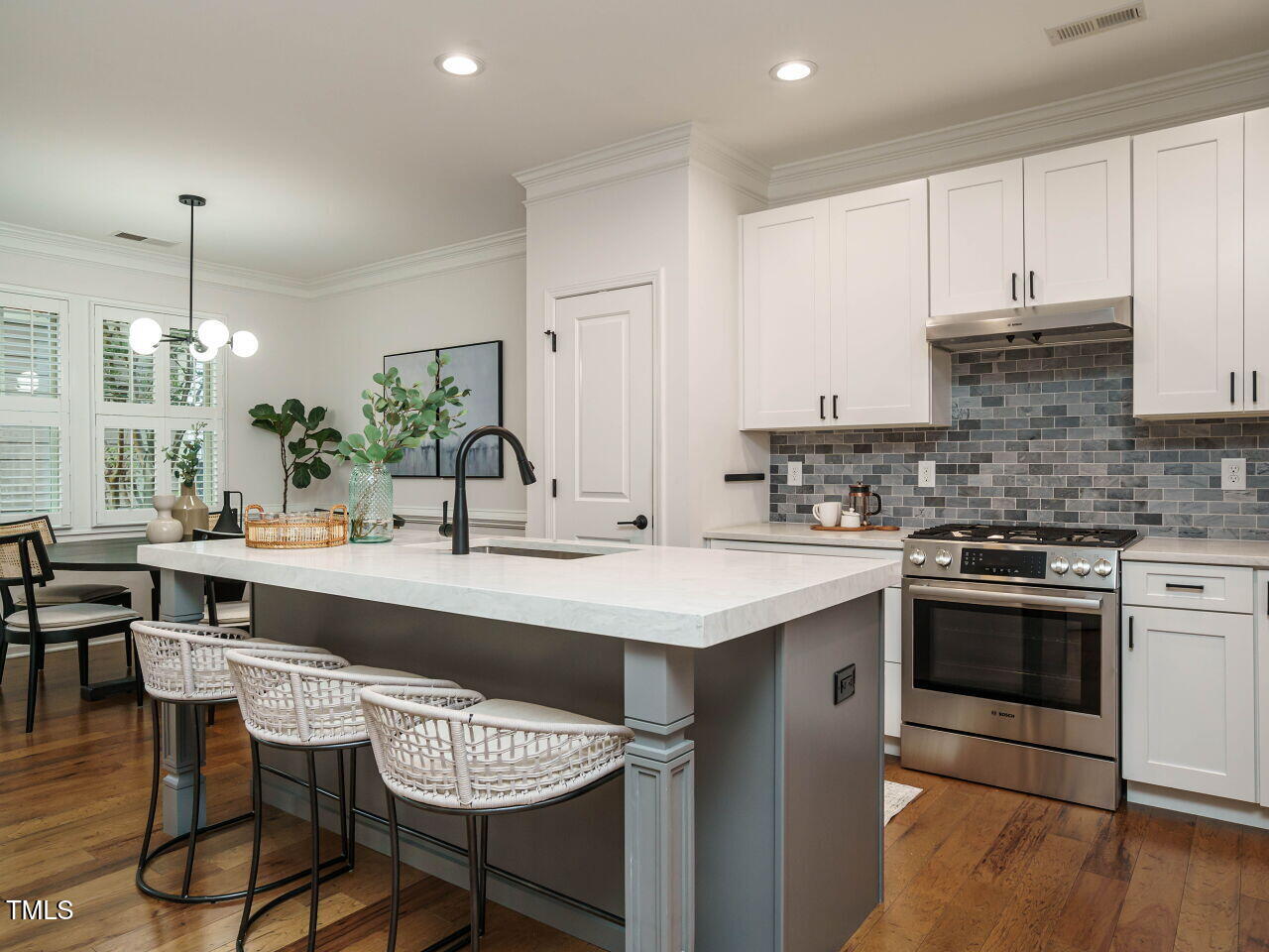 5514 Wade Park Boulevard Raleigh, NC 27607 - Photo 13 of 31 a kitchen with stainless steel appliances stove a sink and chairs