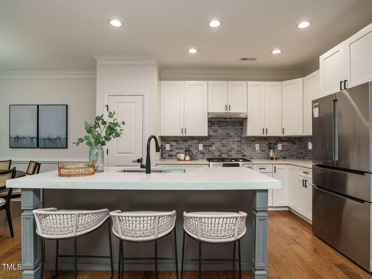 5514 Wade Park Boulevard Raleigh, NC 27607 - Photo 14 of 31 a kitchen with stainless steel appliances granite countertop a dining table chairs refrigerator and cabinets