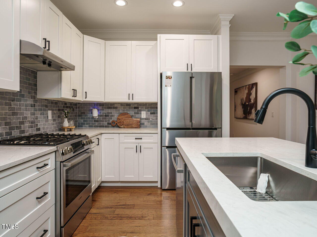 5514 Wade Park Boulevard Raleigh, NC 27607 - Photo 16 of 31 a kitchen with a sink stove and refrigerator