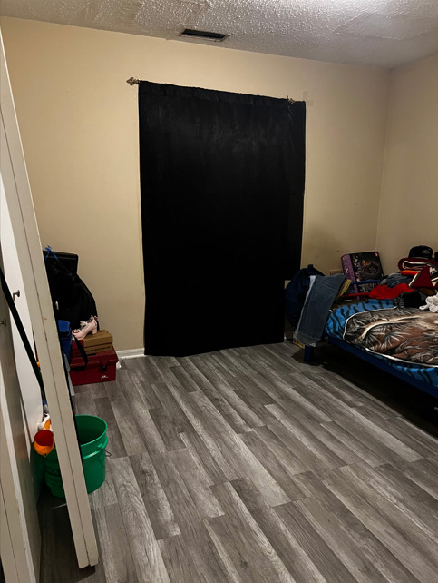 1955 North Hicks Road, Unit 105 Palatine, IL 60074 - Photo 7 of 14 a bedroom with a bed and a dresser