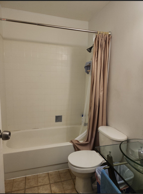 1955 North Hicks Road, Unit 105 Palatine, IL 60074 - Photo 10 of 14 a white toilet sitting next to a bath tub and a shower