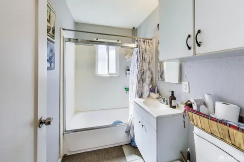 a bathroom with a sink mirror toilet and bathtub