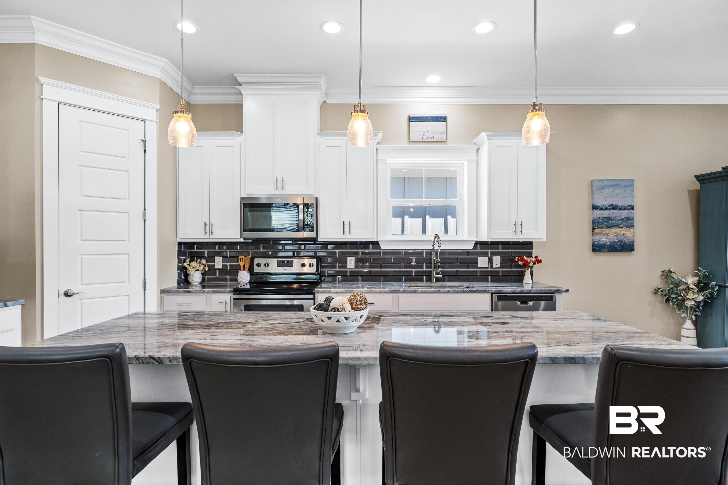 1018 Snapdragon Lane Foley, AL 36535 - Photo 15 of 37 Kitchen with sink, a center island, hanging light fixtures, stainless steel appliances, and white cabinets