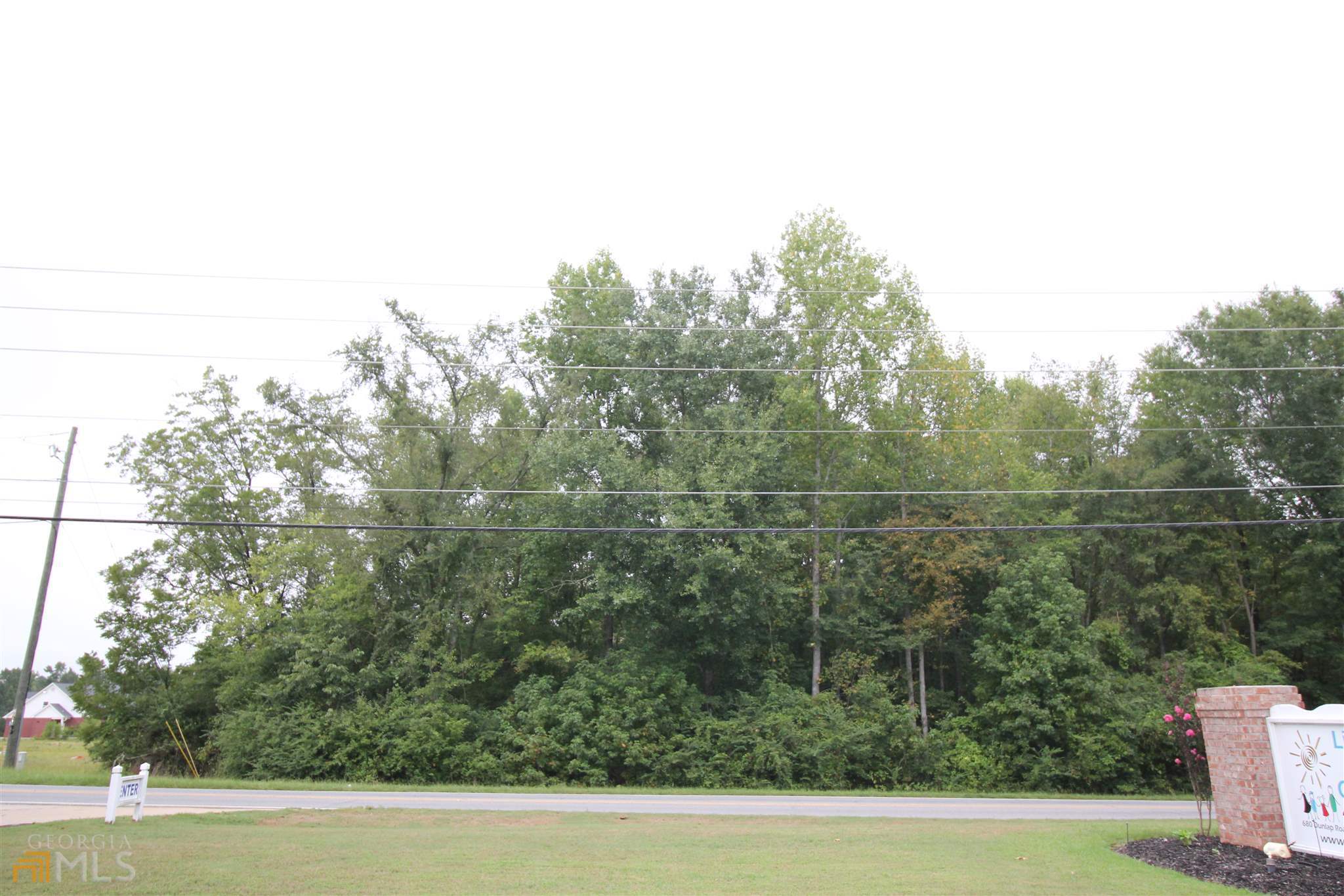 677 Dunlap Road Northeast Milledgeville, GA 31061 - Photo 7 of 7 a view of a green field with lots of bushes