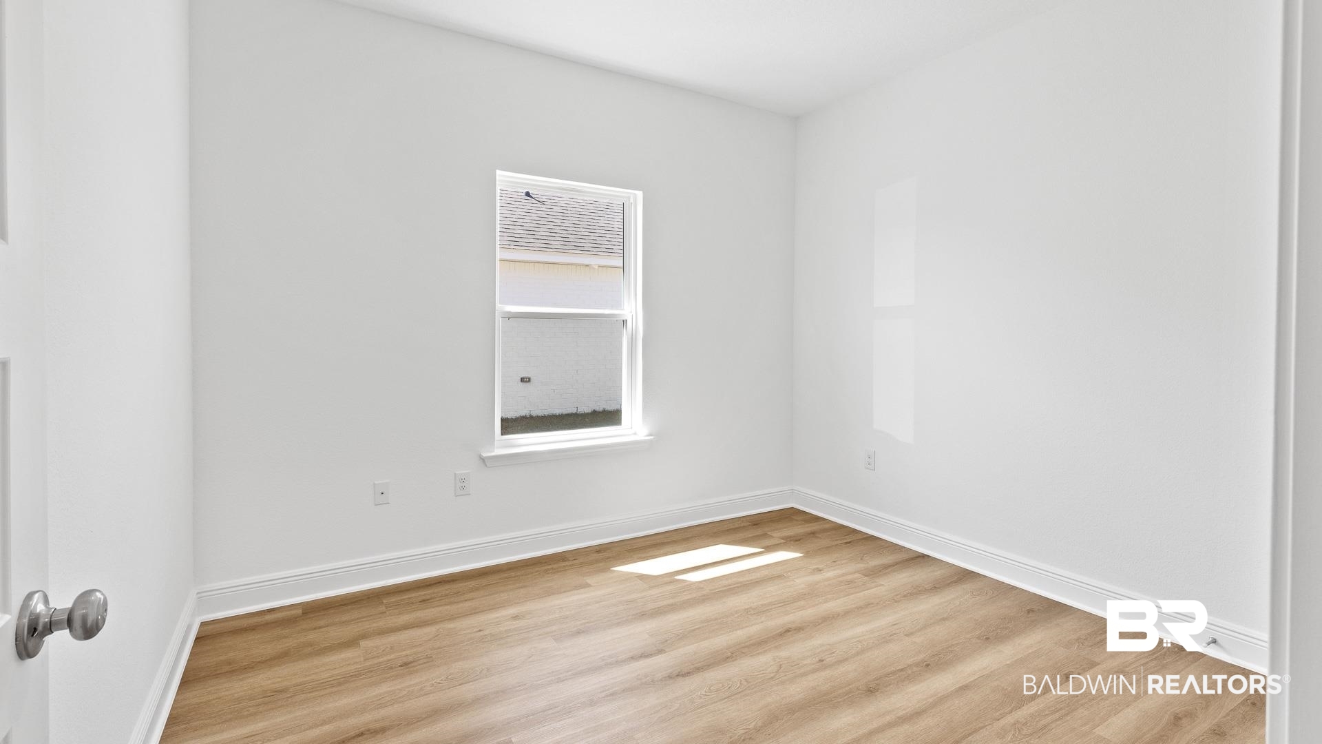 12931 Grand Rpds Road Fairhope, AL 36532 - Photo 11 of 33 Empty room featuring wood finished floors and baseboards