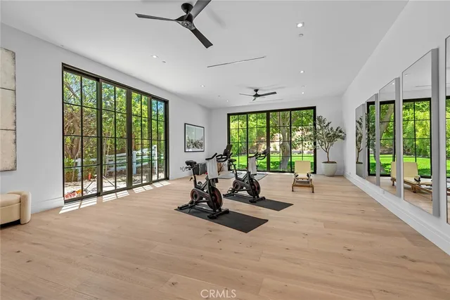 a view of a hallway with wooden floor and furniture