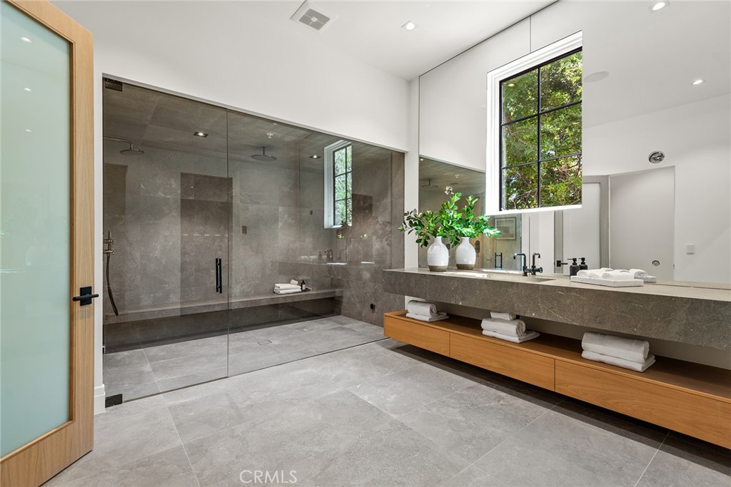 24044 Long Valley Road Hidden Hills, CA 91302 - Photo 20 of 57 a spacious bathroom with a double vanity sink and a bathtub