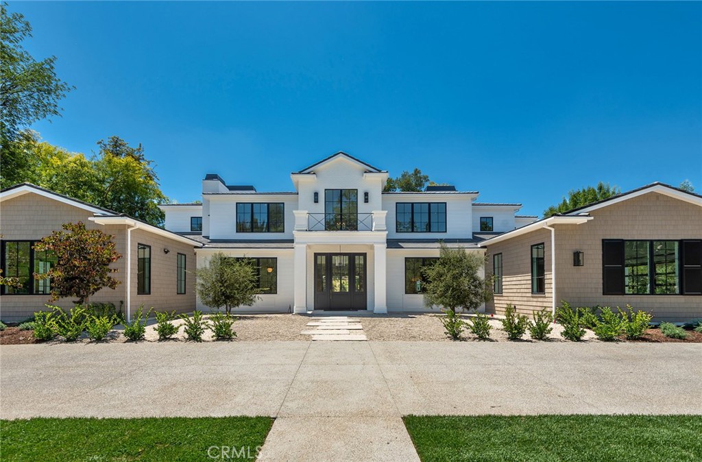 24044 Long Valley Road Hidden Hills, CA 91302 - Photo 2 of 57 a front view of a house with a garden