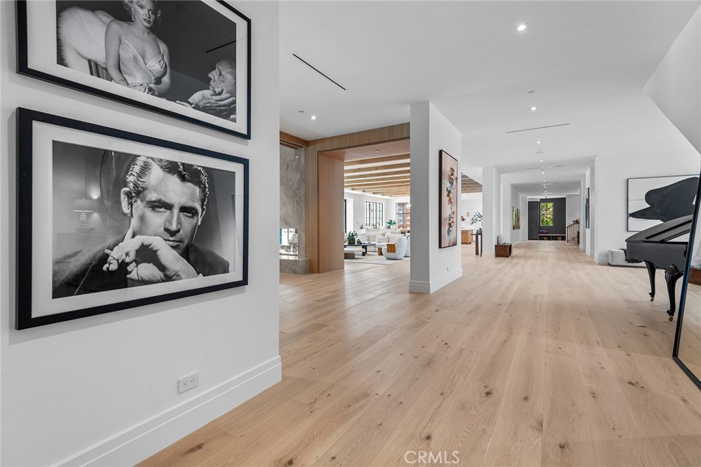 24044 Long Valley Road Hidden Hills, CA 91302 - Photo 21 of 57 a view of a hallway with wooden floor and furniture