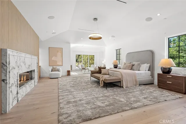 a spacious bathroom with a granite countertop sink a large mirror a bathtub and window