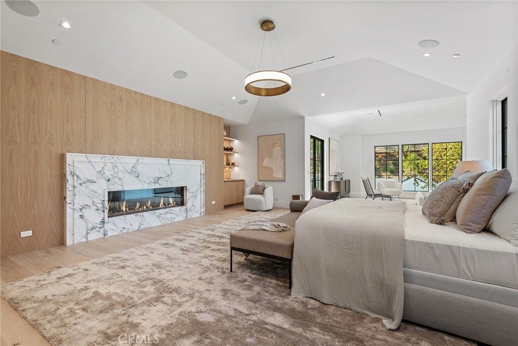 24044 Long Valley Road Hidden Hills, CA 91302 - Photo 25 of 57 a bedroom with a bed and a fireplace