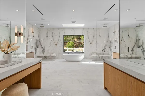 a kitchen with stainless steel appliances granite countertop a sink and a refrigerator