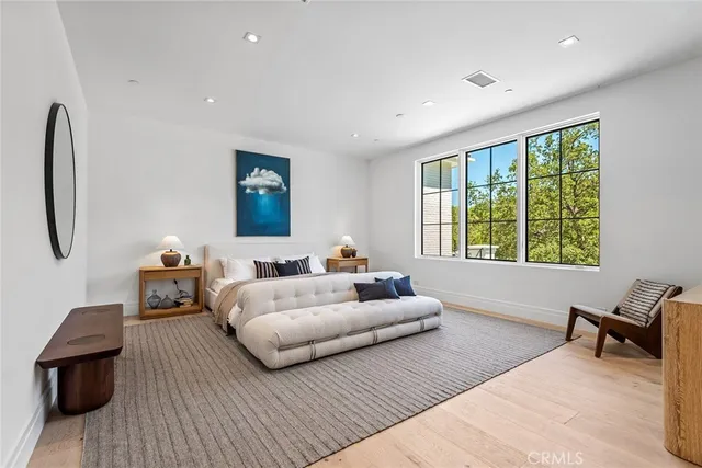 a spacious bathroom with 2 sink flowerpot and a mirror