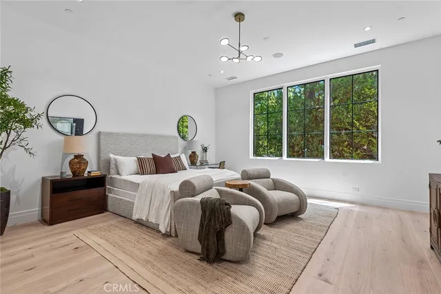 a bathroom with a granite countertop toilet a sink and a mirror