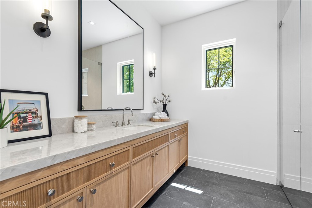 24044 Long Valley Road Hidden Hills, CA 91302 - Photo 40 of 57 a spacious bathroom with 2 sink flowerpot and a mirror
