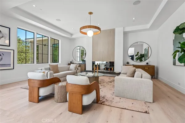 a living room with fireplace furniture and a large window