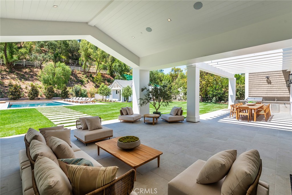 24044 Long Valley Road Hidden Hills, CA 91302 - Photo 45 of 57 a view of a patio with lawn chairs next to a yard