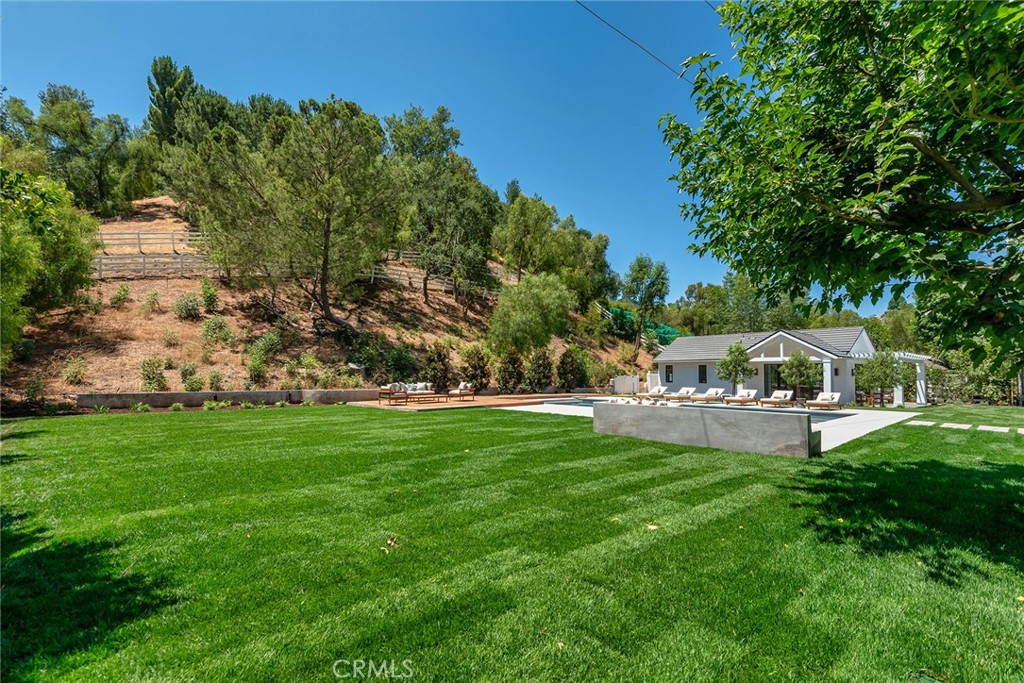 24044 Long Valley Road Hidden Hills, CA 91302 - Photo 50 of 57 a view of a garden with a house in the background