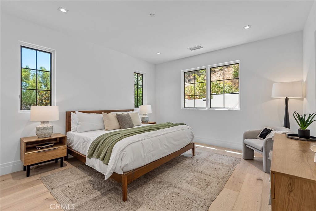 24044 Long Valley Road Hidden Hills, CA 91302 - Photo 54 of 57 a bed room with a bed and a potted plant