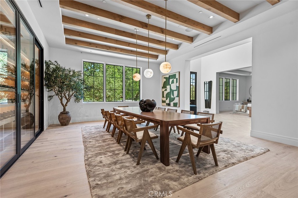 24044 Long Valley Road Hidden Hills, CA 91302 - Photo 7 of 57 a dining room with furniture a chandelier and wooden floor