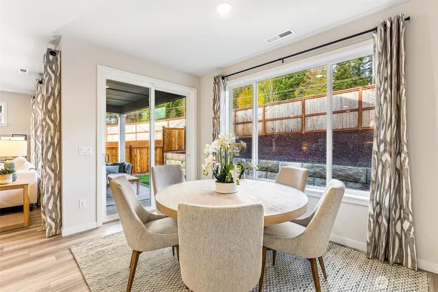 a dining room with furniture window and outside view