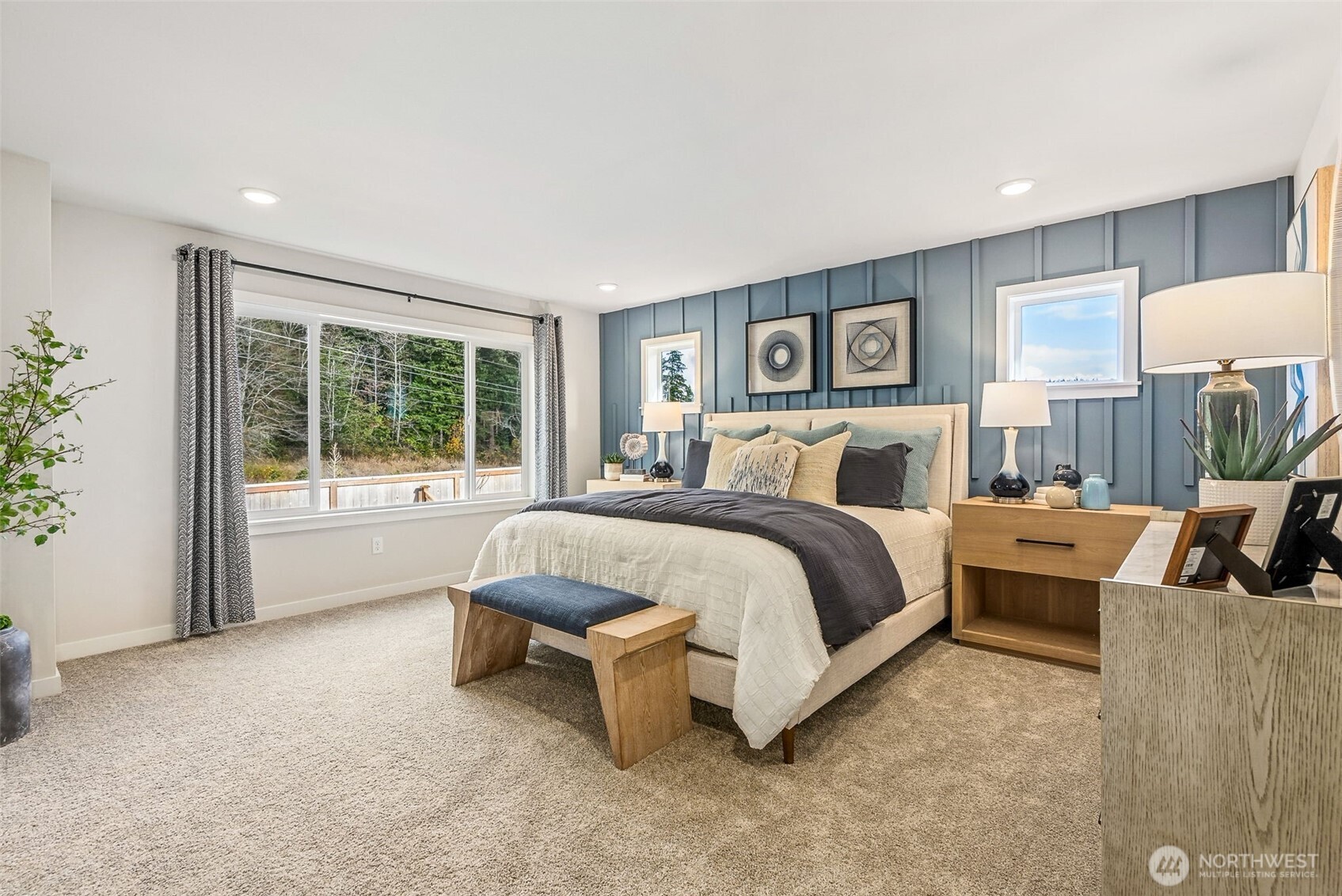 17535 Northeast Midnight Sun Loop Poulsbo, WA 98370 - Photo 21 of 38 a spacious bedroom with a bed and a large window